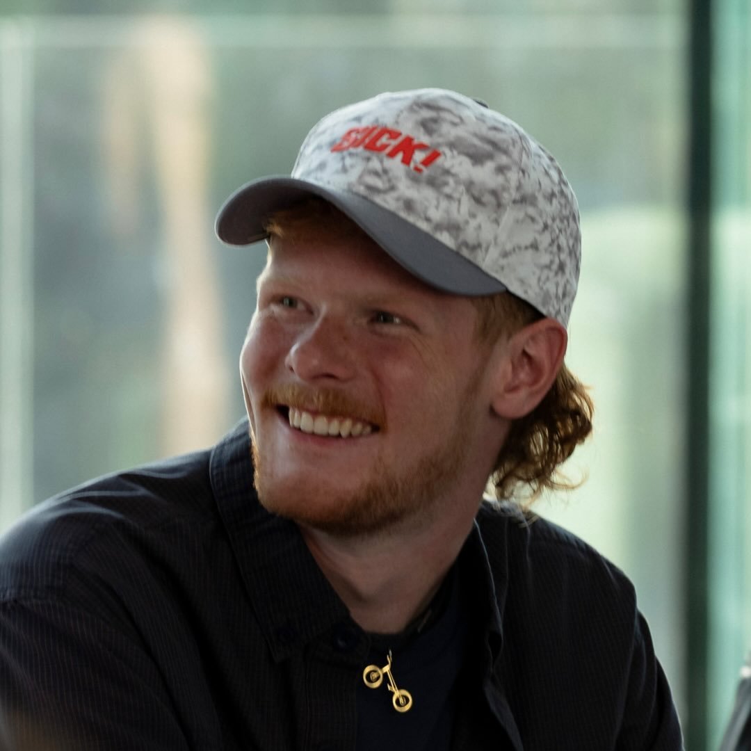 Andrew Crabtree smiling, wearing a cap