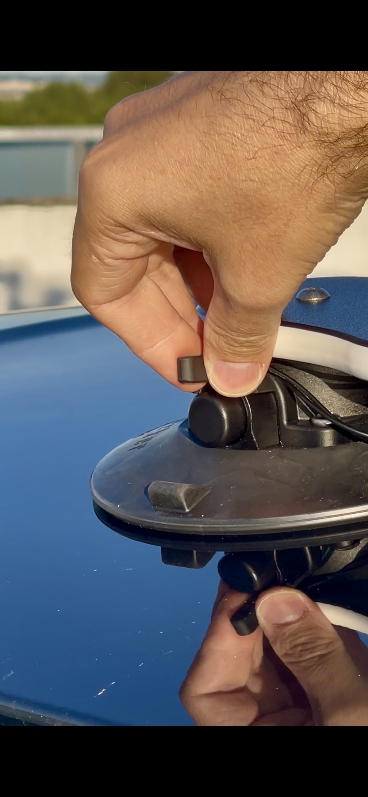 Kraken sensor attached to a SeaSucker vacuum mount on a car roof
